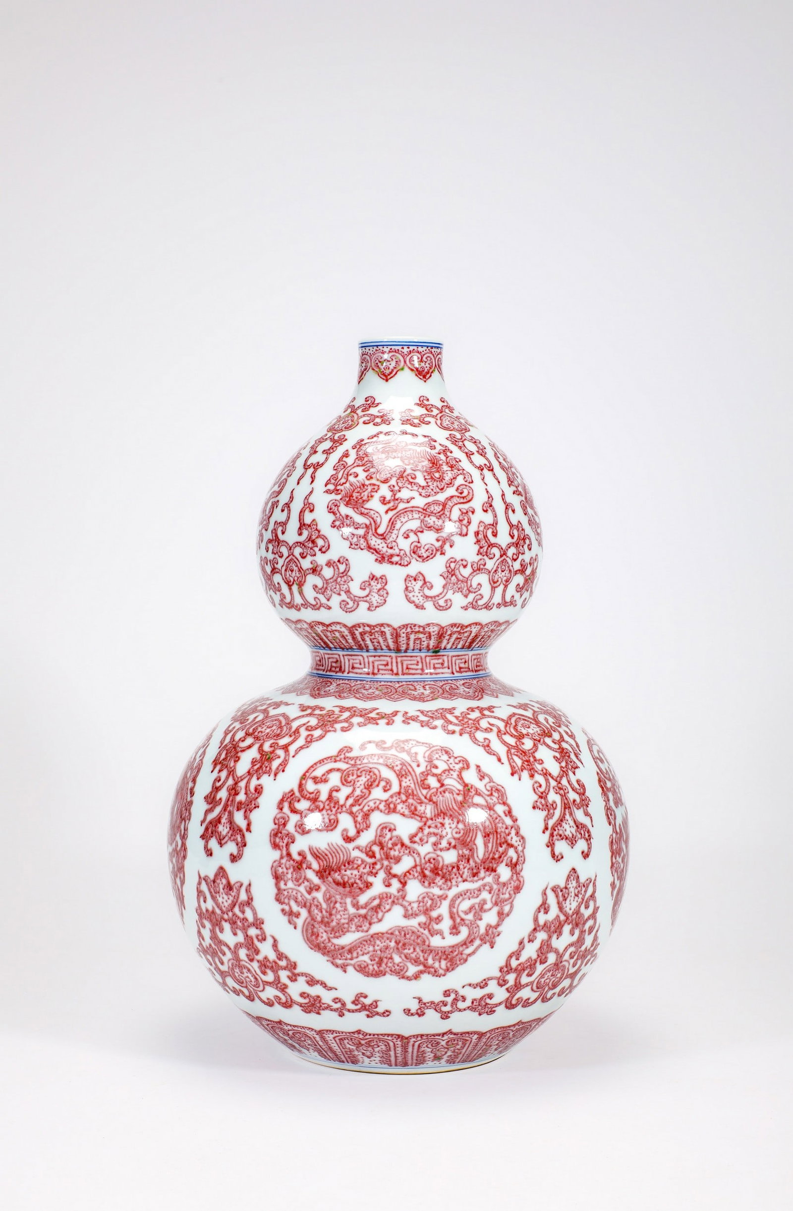 A COPPER-RED DRAGON DOUBLE-GOURD VASE: 清乾隆釉里红团龙纹葫芦瓶 A copper-red dragon double-gourd vase Ht.32cm