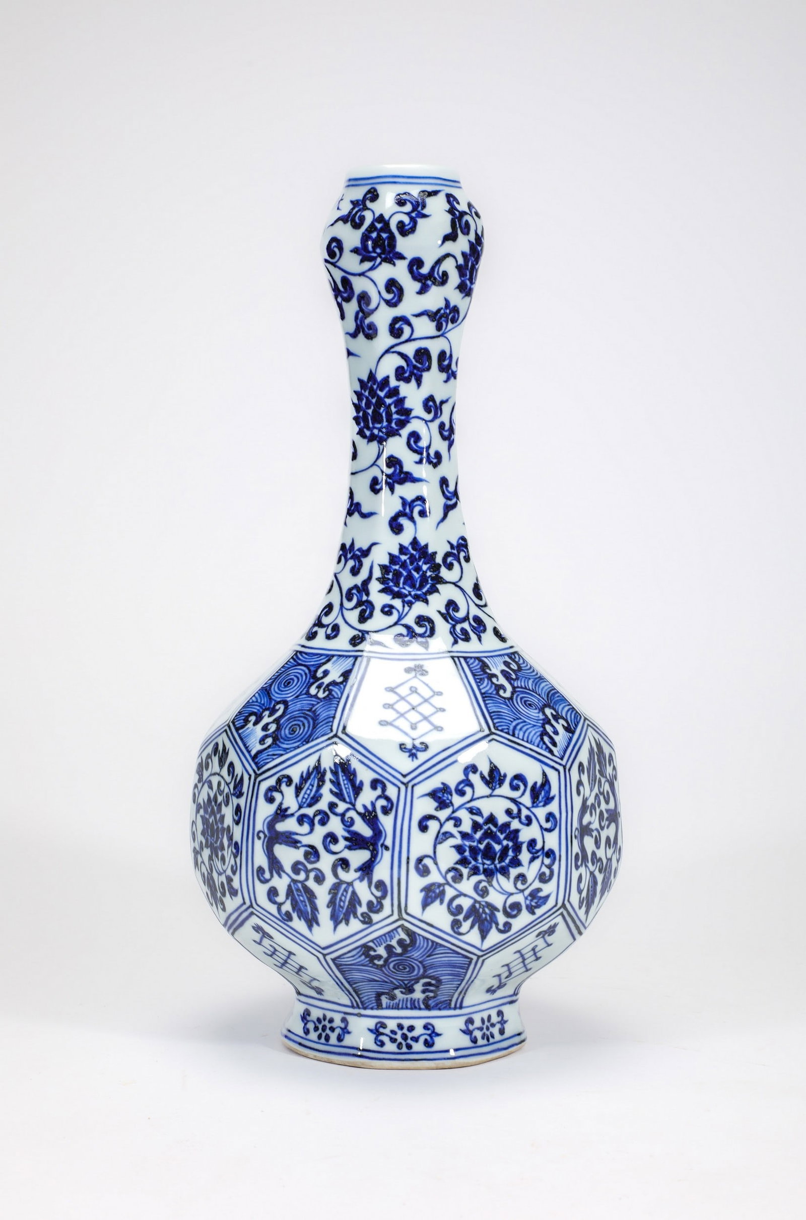 A BLUE AND WHITE LOTUS VASE: 明宣德青花缠枝莲纹蒜头瓶 A blue and white lotus vase Ht.34cm
