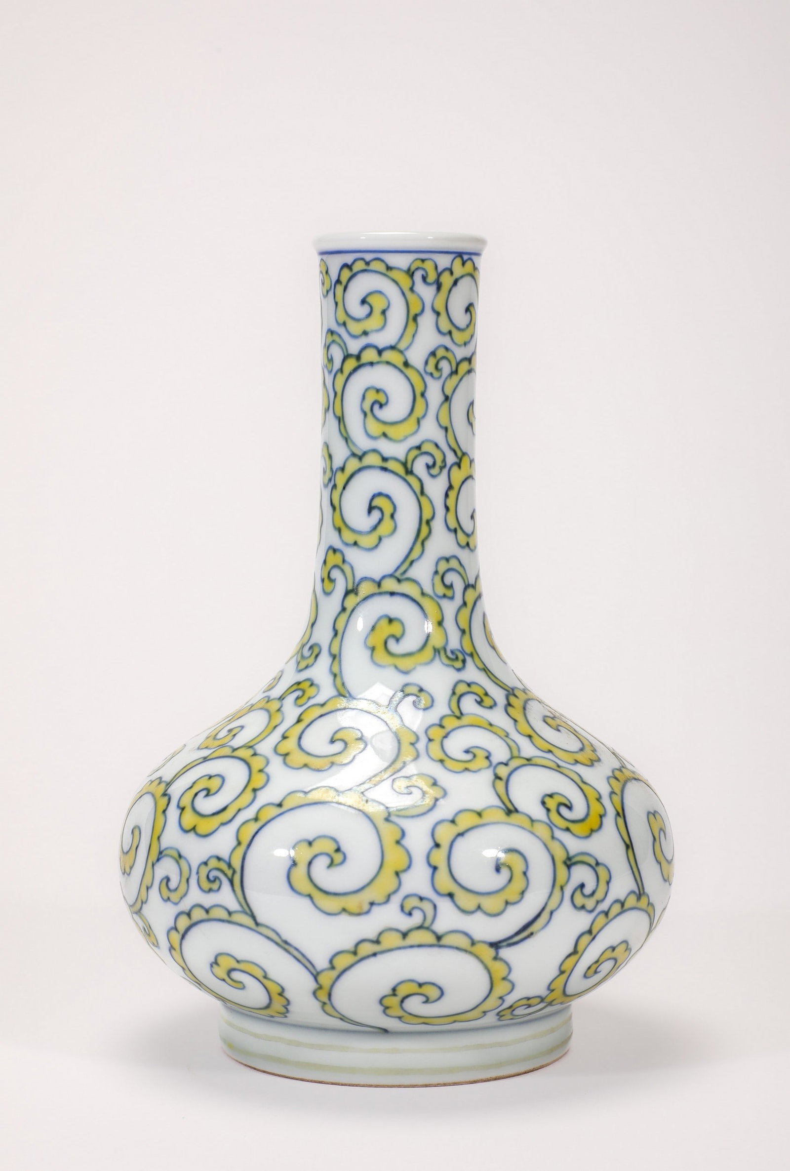A DOUCAI FLORAL VASE: 明成化斗彩卷草纹荸荠瓶 A doucai floral vase Ht.20cm