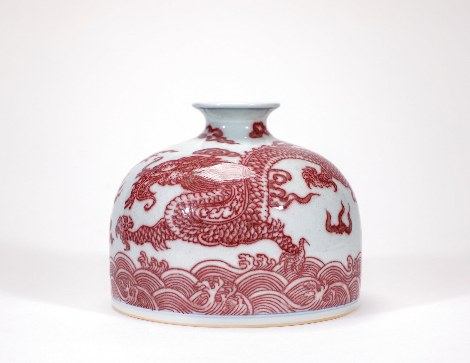 A COPPER-RED DRAGON ZUN: 清康熙釉里红海水龙纹太白尊 A copper-red dragon zun Ht.11cm Diam.13cm