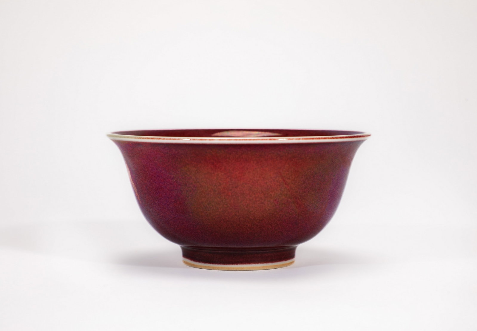 A RED GLAZED CUP: 明宣德红釉压手杯 A red glazed cup Diam.10cm Ht.15cm