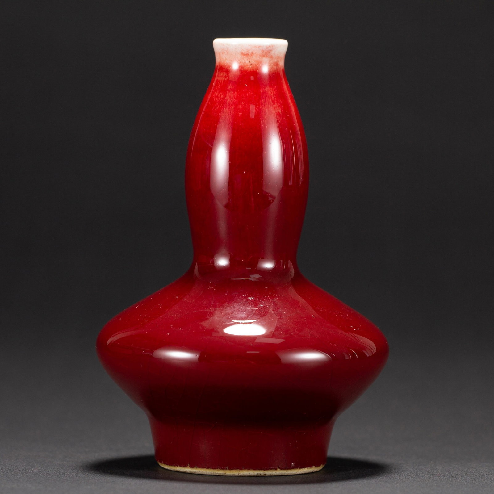 A RED GLAZED VASE: 祭红釉瓶 A red glazed vase Ht.13CM