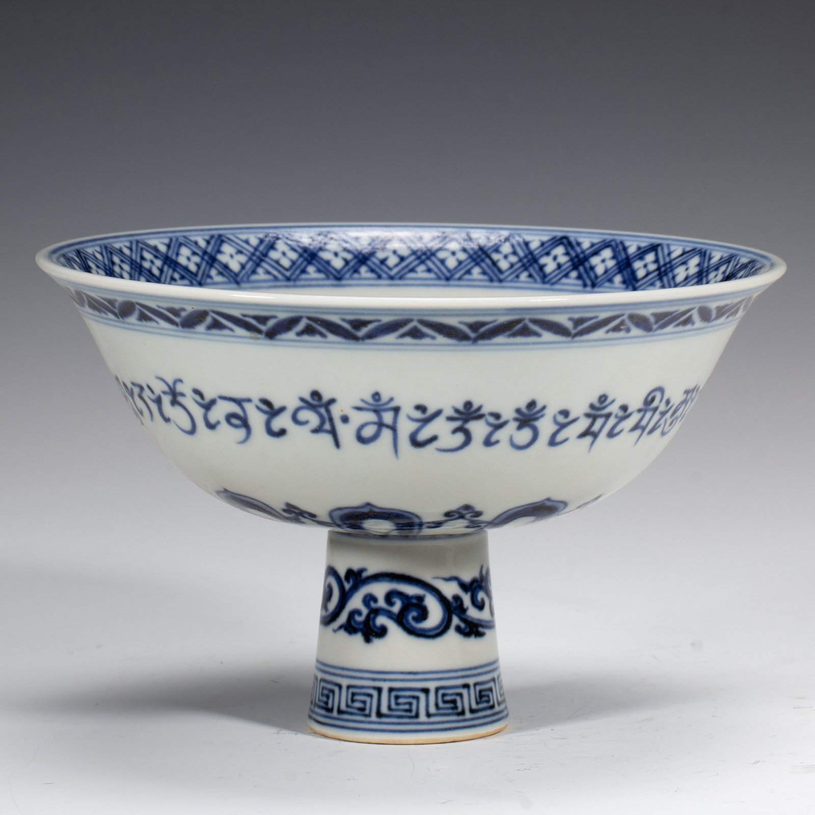 A BLUE AND WHITE FLORAL CUP: 青花阿文杯 A blue and white floral cup Ht.11CM