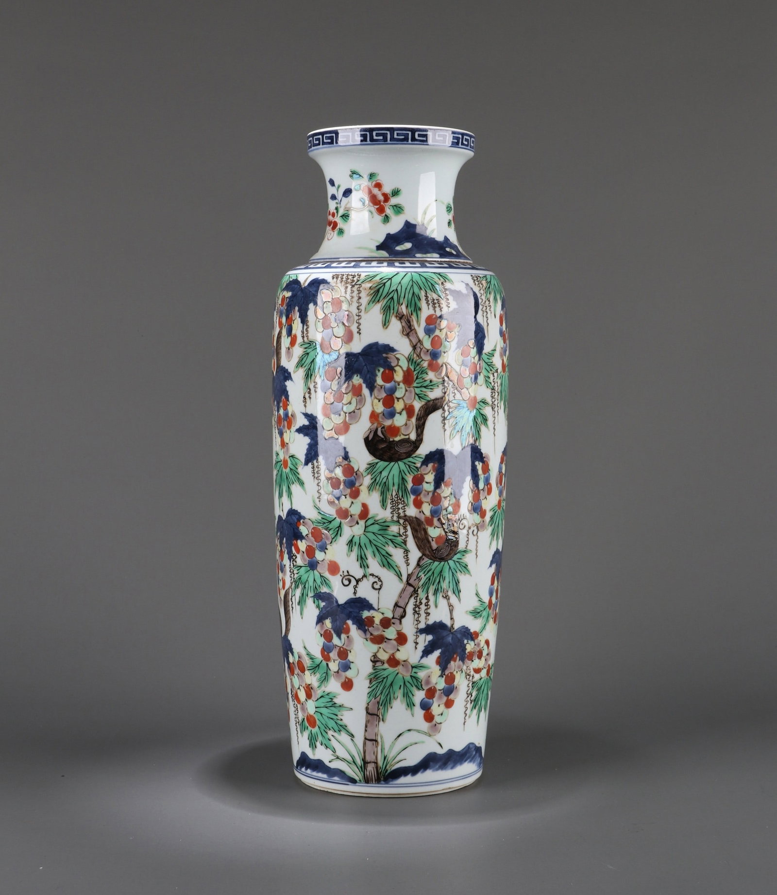 A BLUE AND WHITE WUCAI SQUIRREL GRAPE VASE: 清 青花五彩通景松鼠葡萄纹筒瓶 A blue and white wucai squirrel grape vase Ht.41cm