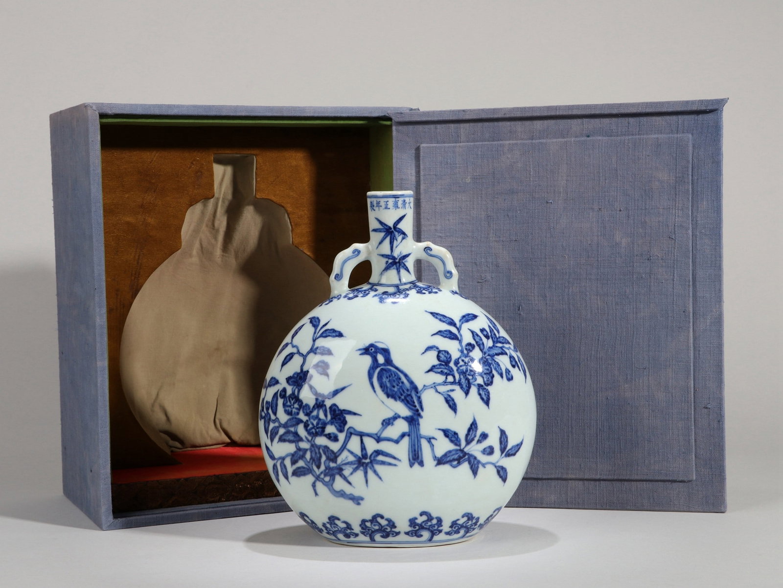 A BLUE AND WHITE BIRD MOONFLASK: 雍正 青花花鸟纹抱月瓶 A blue and white bird moonflask Ht.23cm