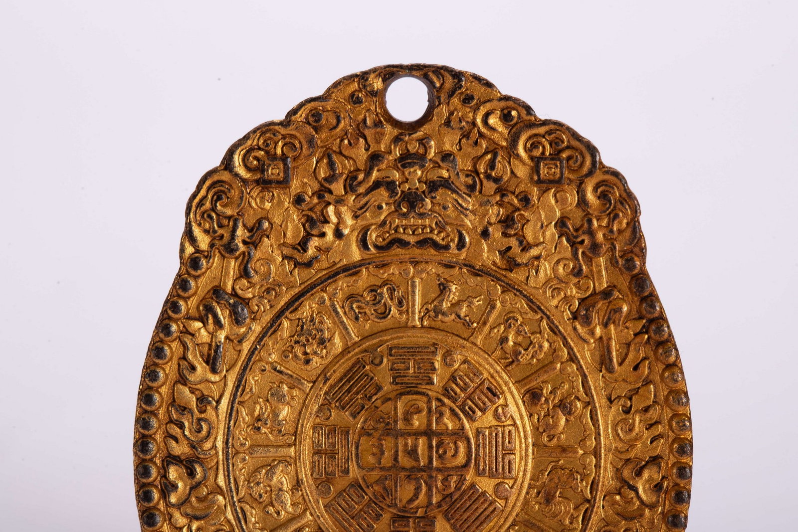 A COPPER GILDED PENDANT - 2