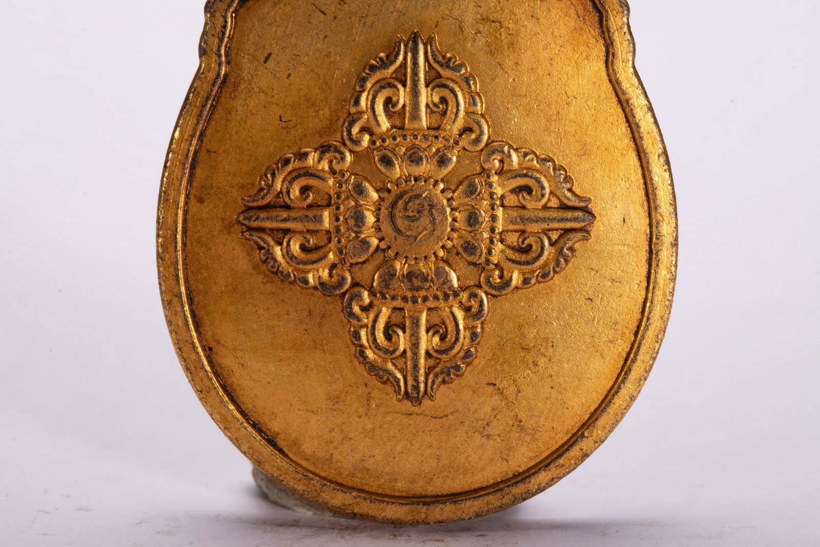 A COPPER GILDED PENDANT - 7