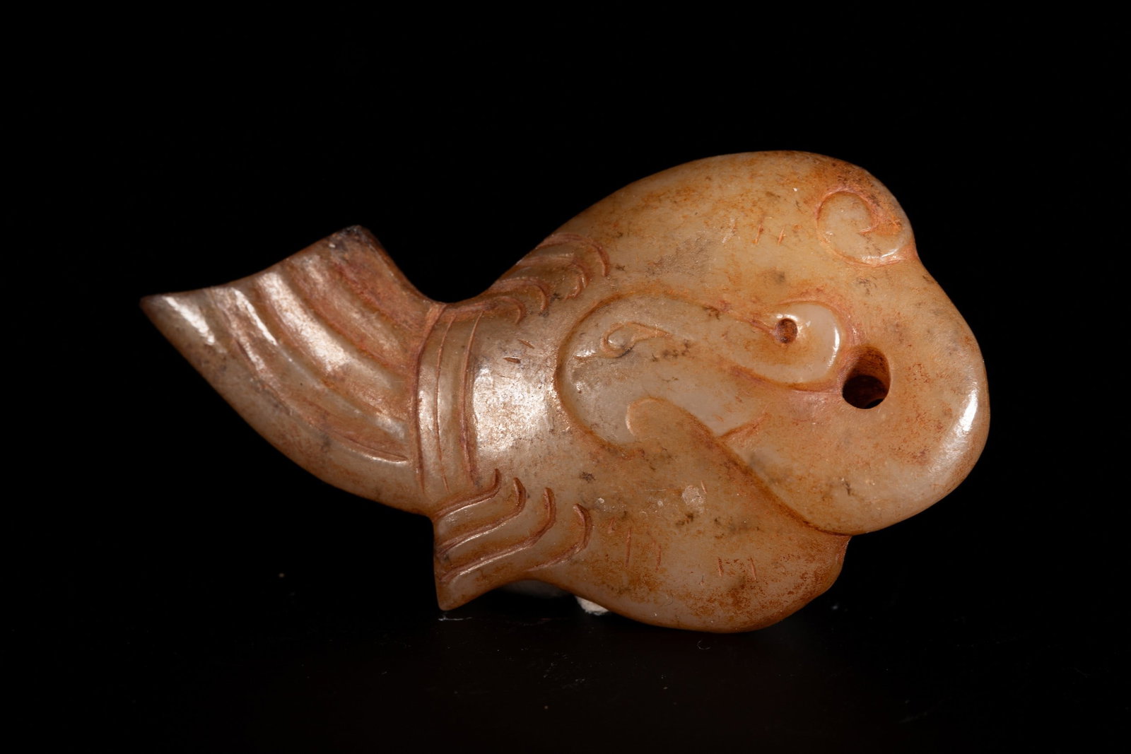 A JADE PENDANT: 和田玉鱼形佩 A jade pendant 6x3.3cm