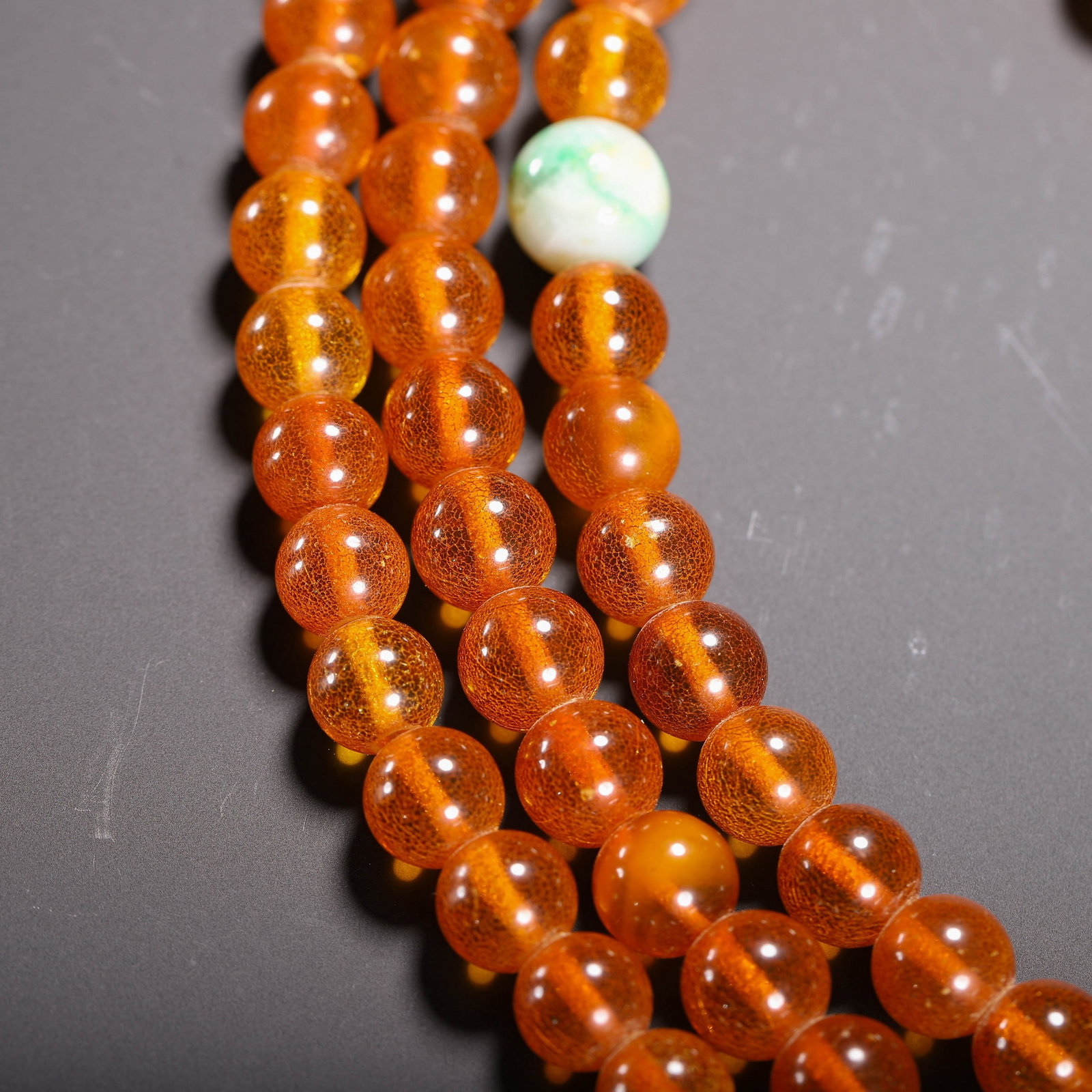 AN AMBER PRAYER BEAD - 5