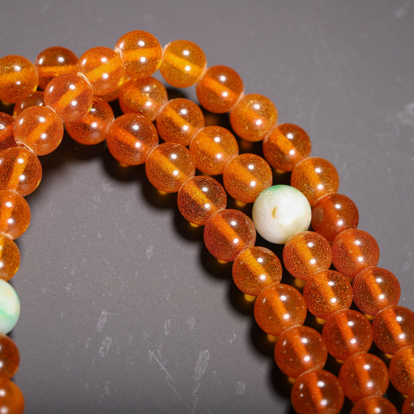AN AMBER PRAYER BEAD - 7