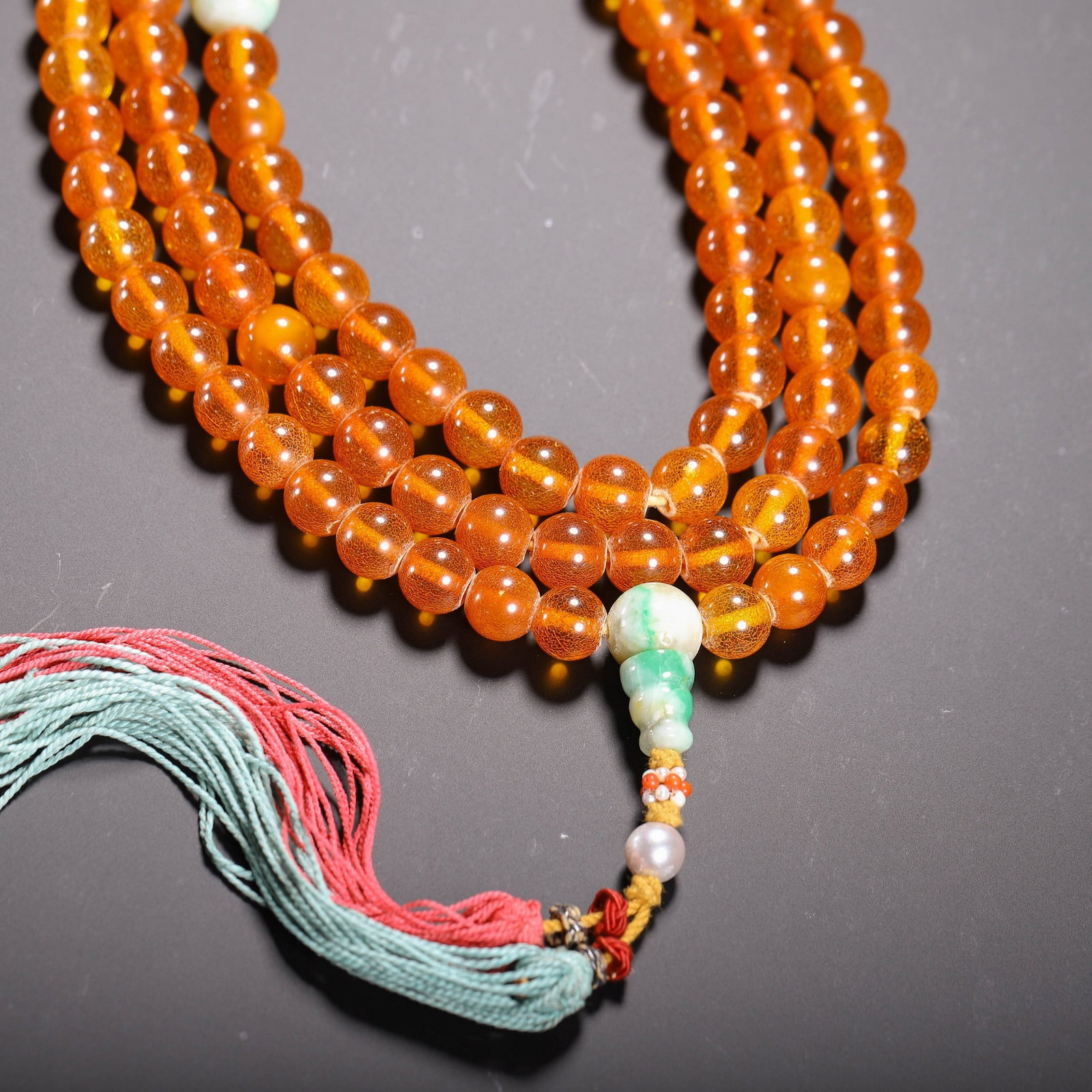 AN AMBER PRAYER BEAD - 9