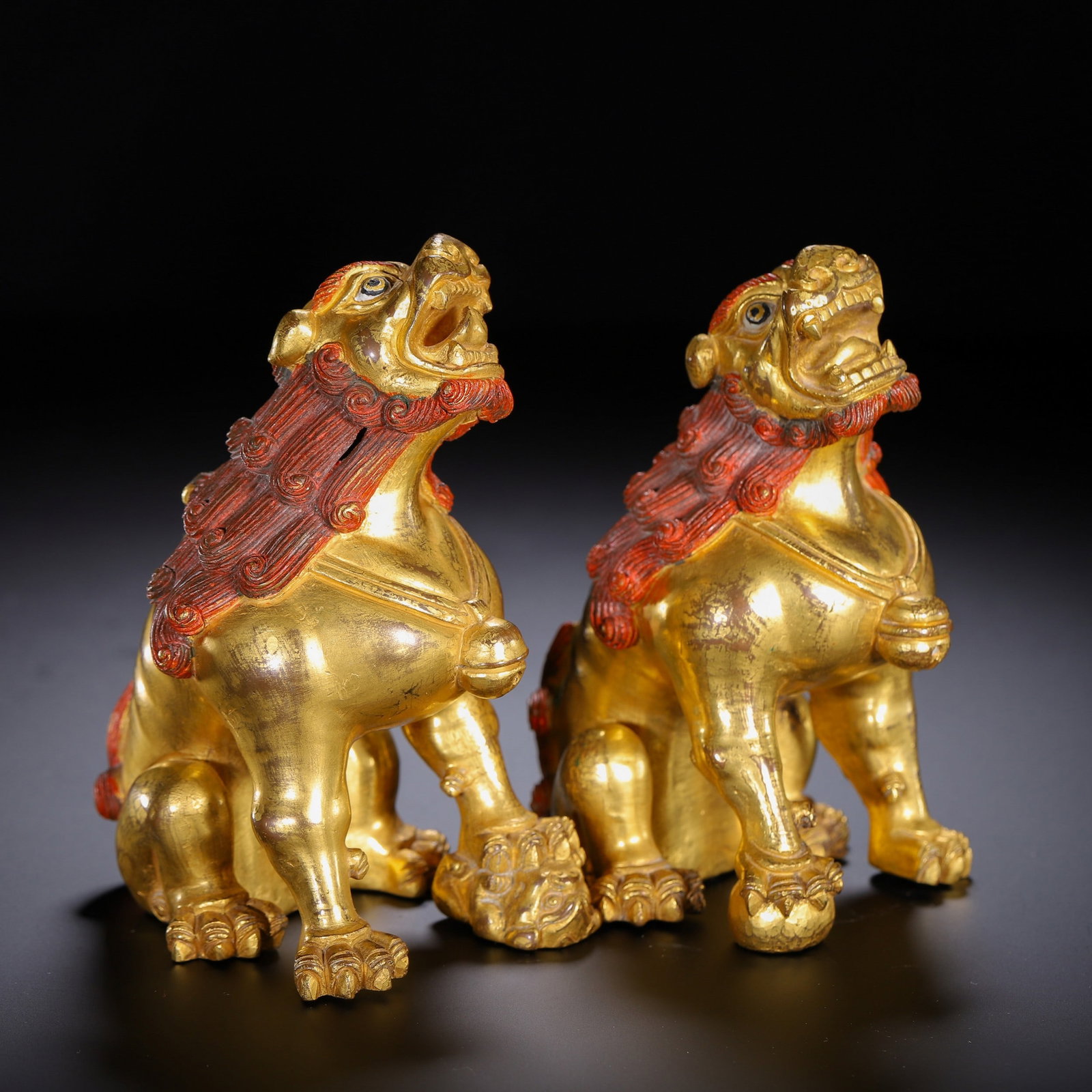 A PAIR OF COPPER GILDED LIONS: 铜鎏金狮子一对 A pair of copper gilded lions Ht.12.5cm