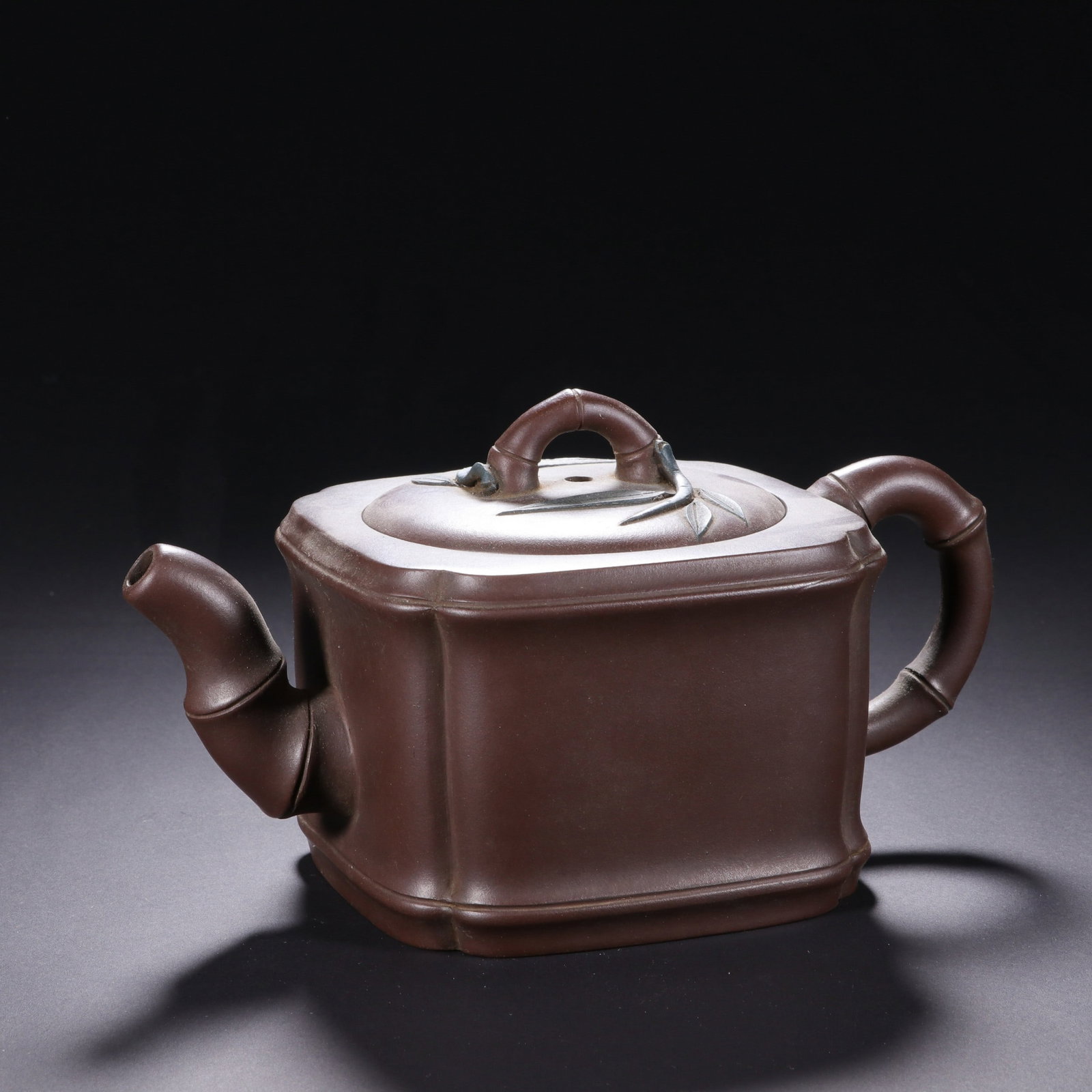 A ZISHA BAMBOO TEAPOT: 紫砂竹节壶 A zisha bamboo teapot Ht.9cm Lg.17cm