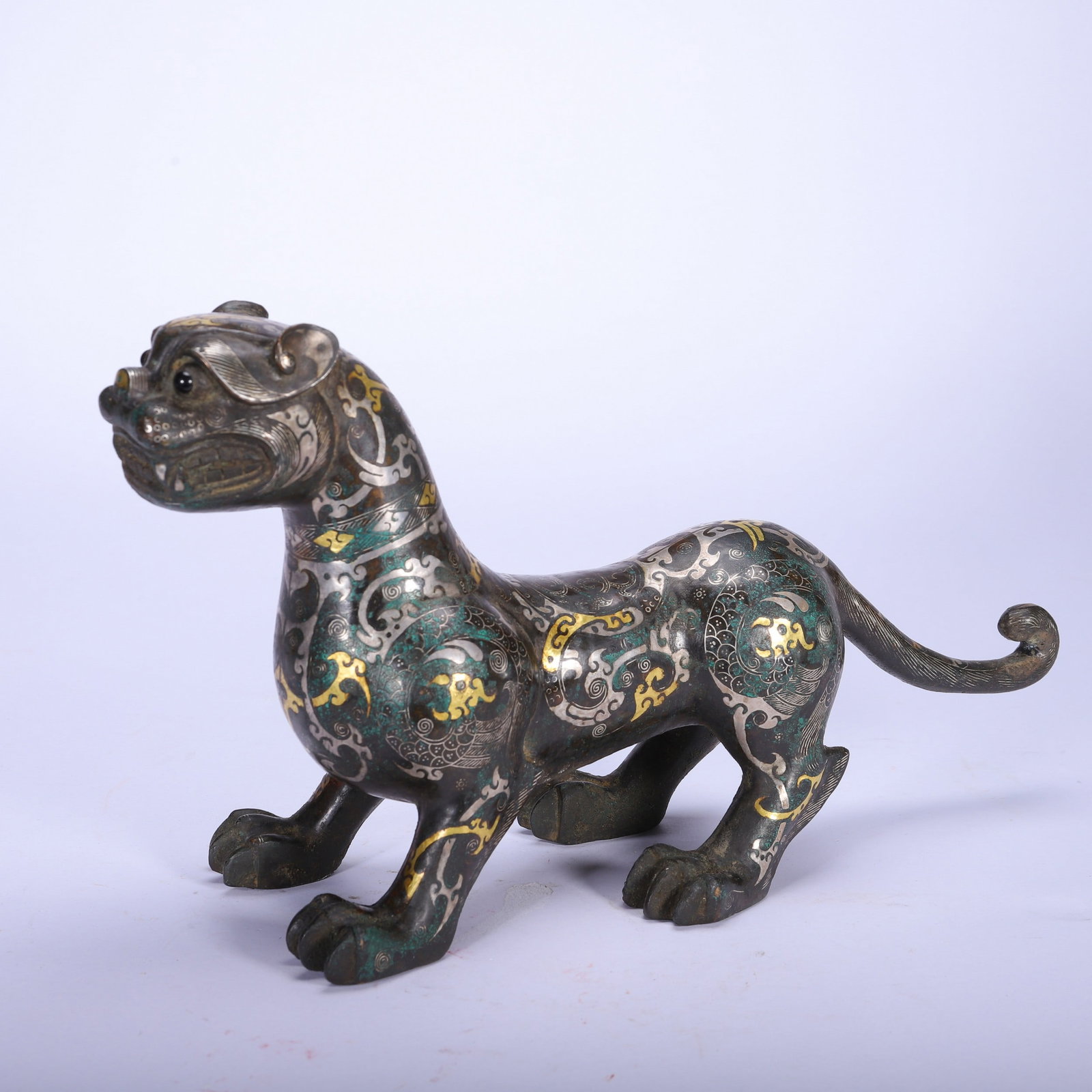A COPPER GOLD AND SILVER BEAST: 铜错金银瑞兽 A copper gold and silver beast Lg.23cm Ht.19cm