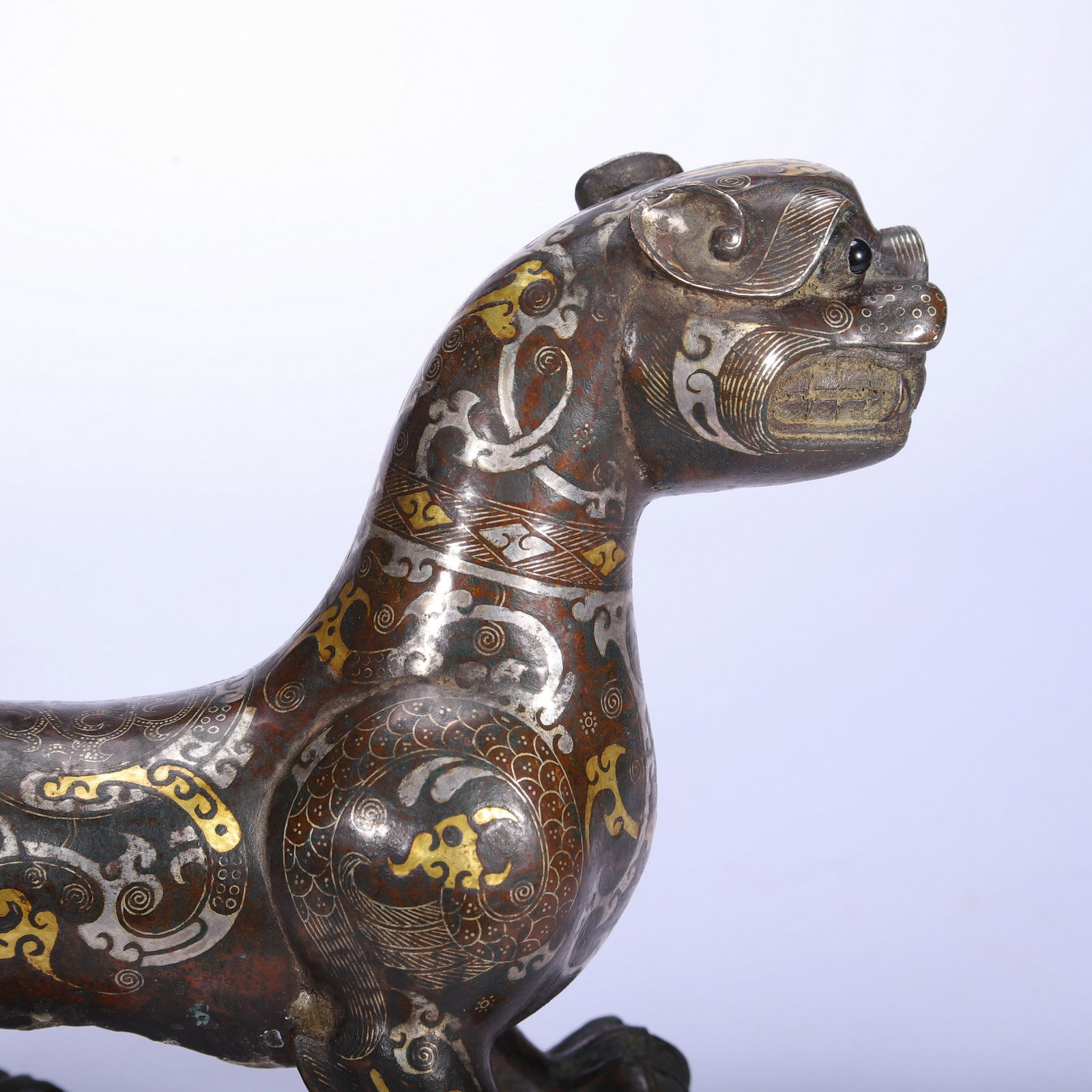 A COPPER GOLD AND SILVER BEAST - 6