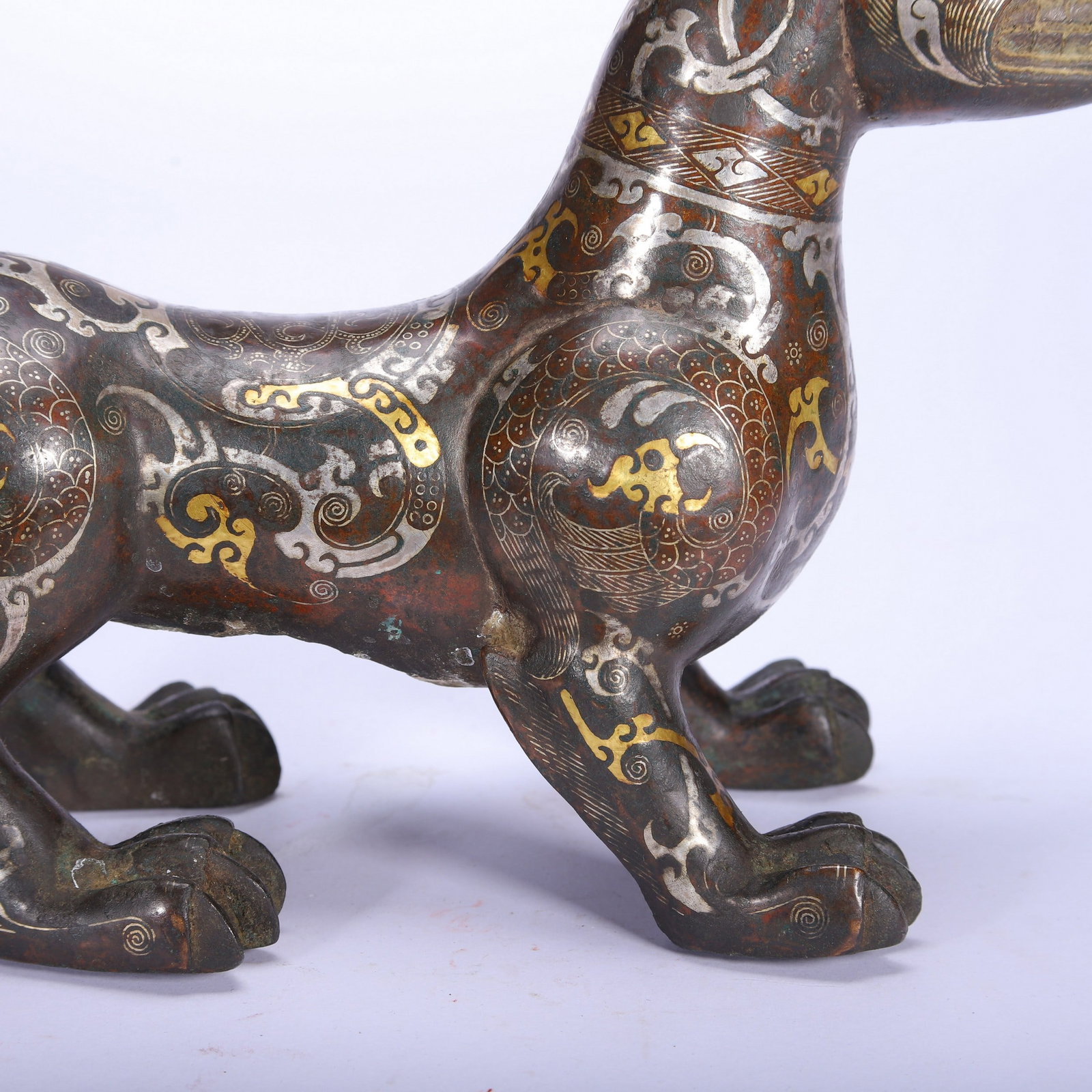 A COPPER GOLD AND SILVER BEAST - 7