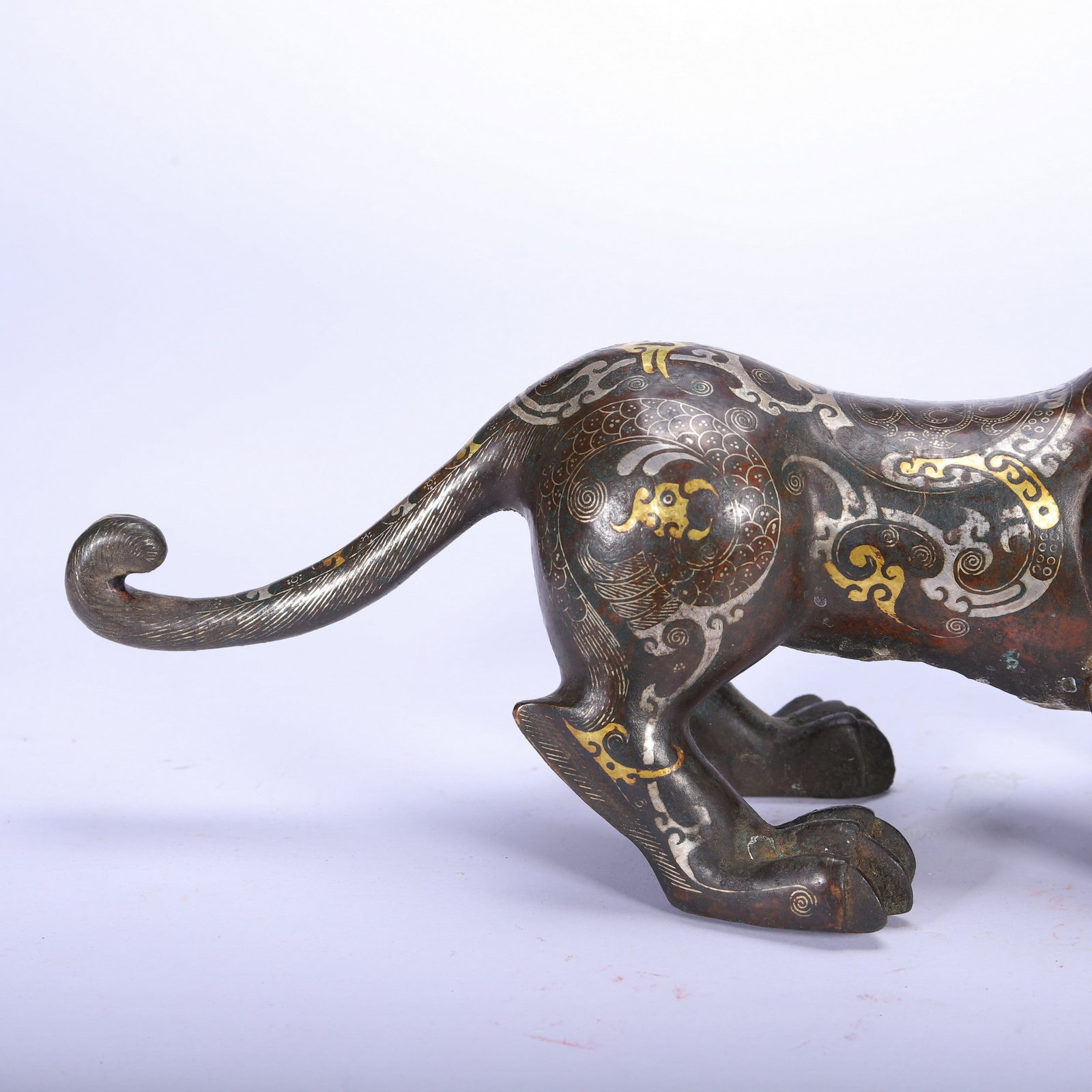 A COPPER GOLD AND SILVER BEAST - 8