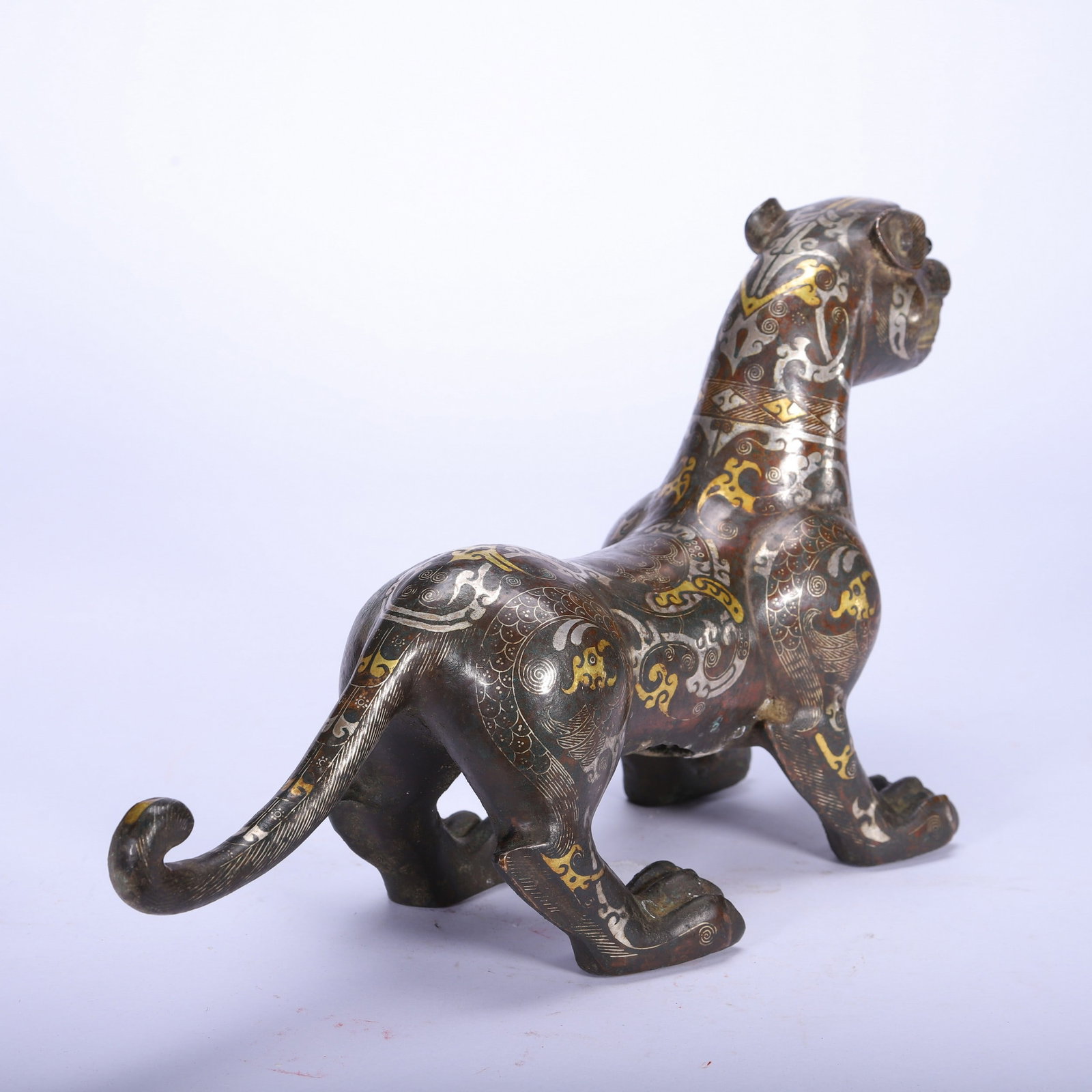 A COPPER GOLD AND SILVER BEAST - 9