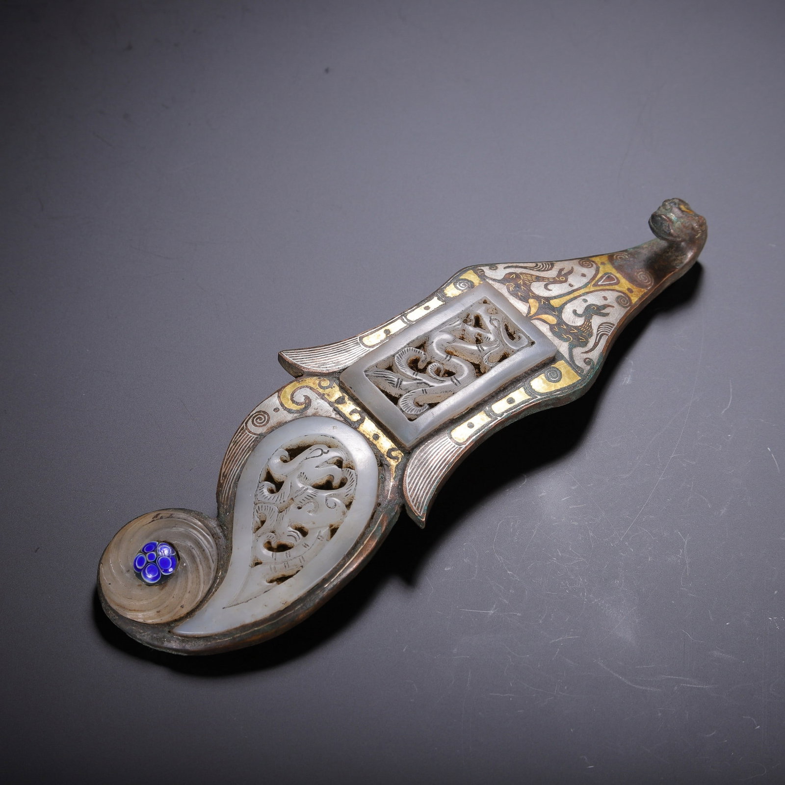 A COPPER GOLD AND SILVER COVERED BELT HOOK: 铜错金银嵌白玉带钩 A copper gold and silver covered belt hook Lg.18cm