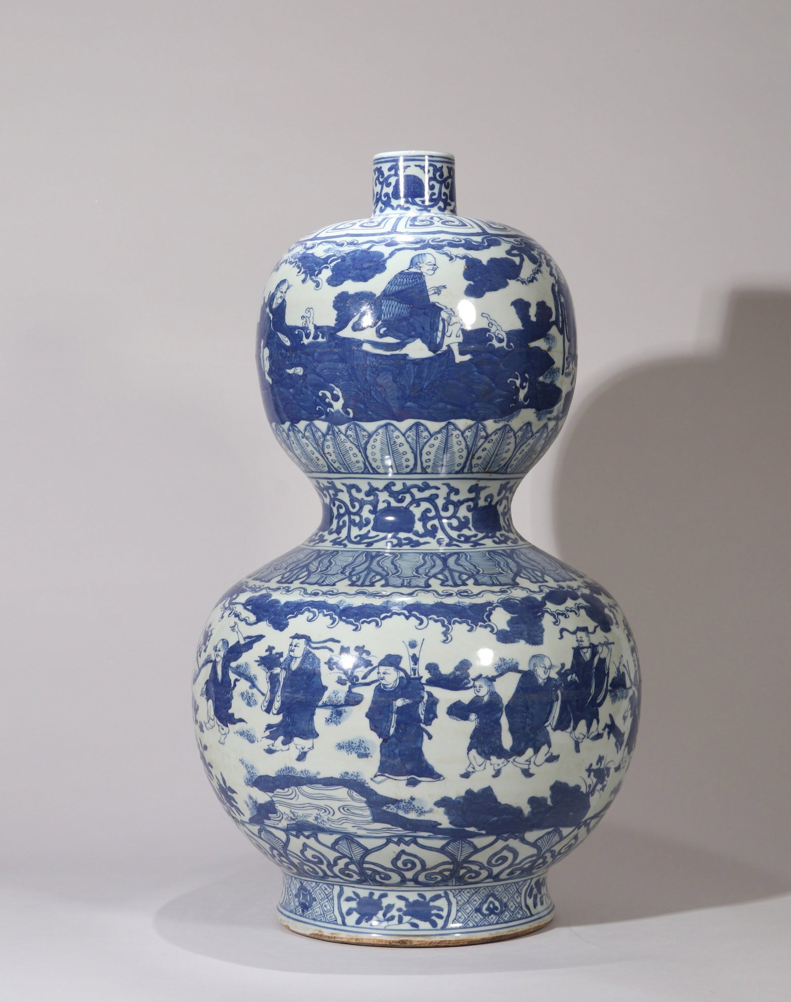 A LARGE BLUE AND WHITE FIGURE DOUBLE-GOURD VASE: 万历 青花群仙祝寿纹大葫芦瓶 A large blue and white figure double-gourd vase Ht.56cm