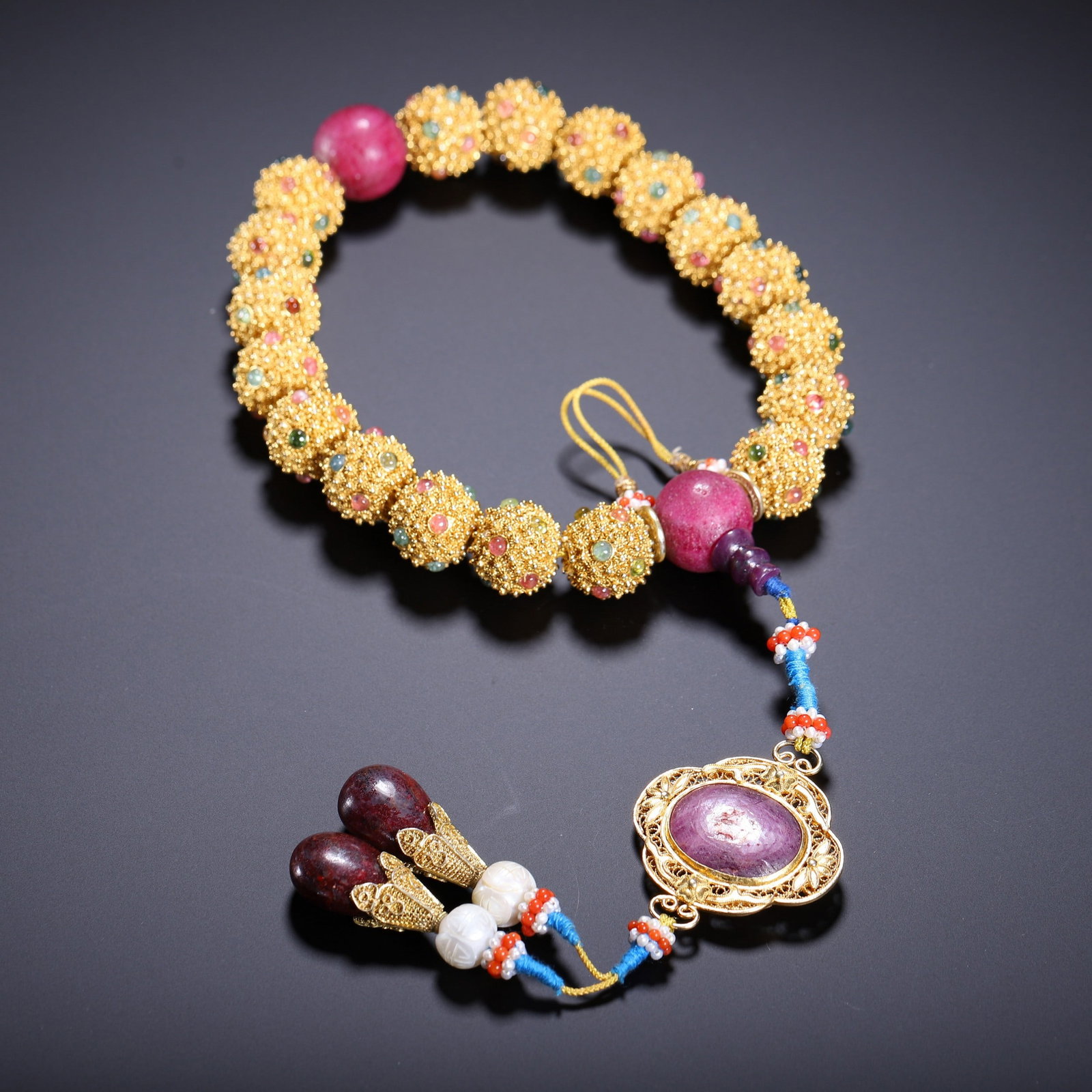A COPPER GILDED BRACELET: 清 铜鎏金嵌宝手持 A copper gilded bracelet Diam.2cm