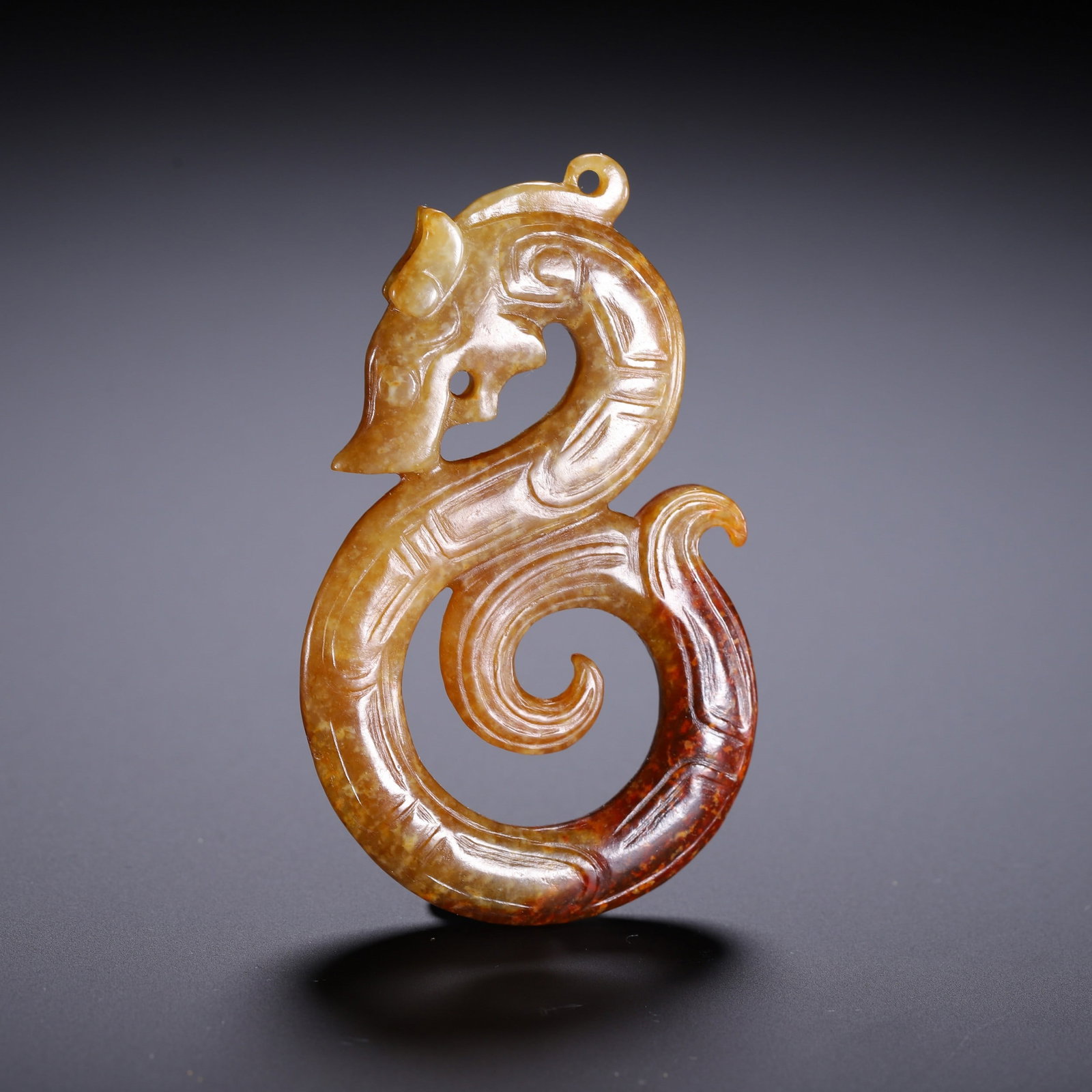 A JADE PENDANT: 清 和田龙纹挂件 A jade pendant Lg.6.6cm