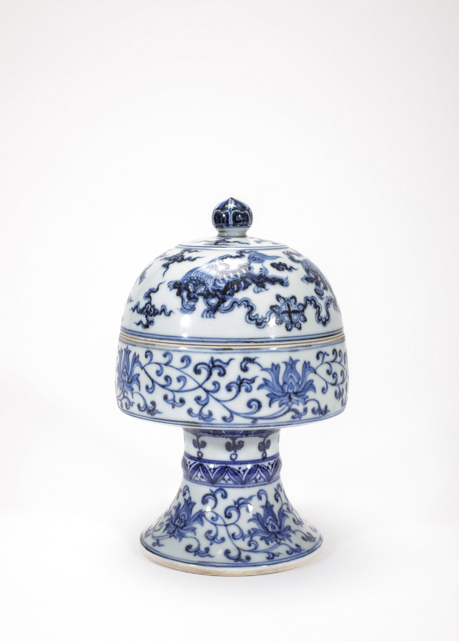 A BLUE AND WHITE FLORAL LION DOU: 明宣德青花缠枝莲狮子纹豆 A blue and white floral lion dou Diam.12.5cm Ht.21cm