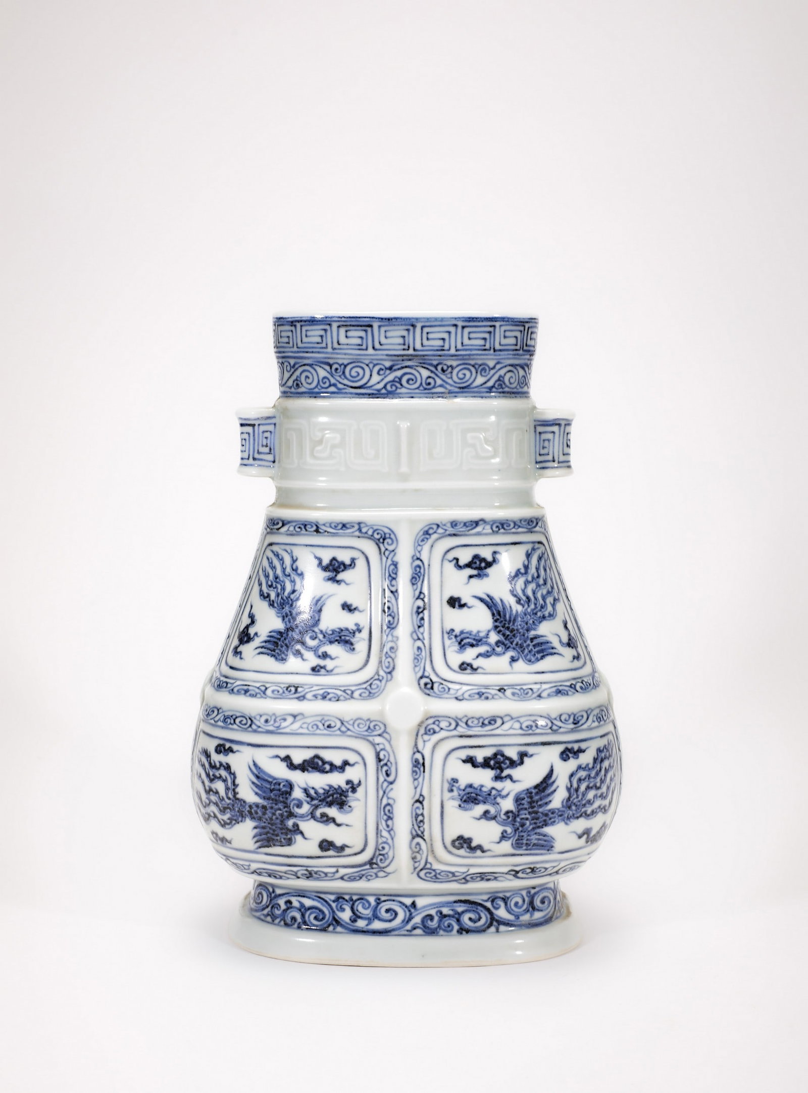 A BLUE AND WHITE DRAGON AND PHOENIX VASE: 明宣德青花开窗云凤纹贯耳瓶 A blue and white dragon and phoenix vase Ht.25cm