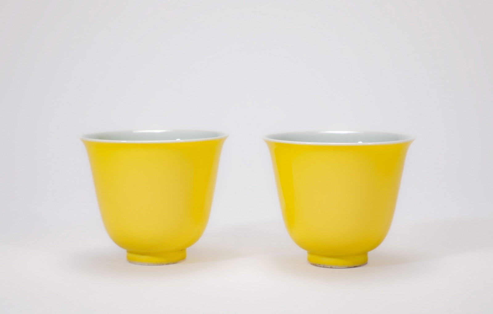 A PAIR OF YELLOW GLAZED CUPS: 清雍正黄釉杯一对 A pair of yellow glazed cups Diam.6.5cm Ht.6cm