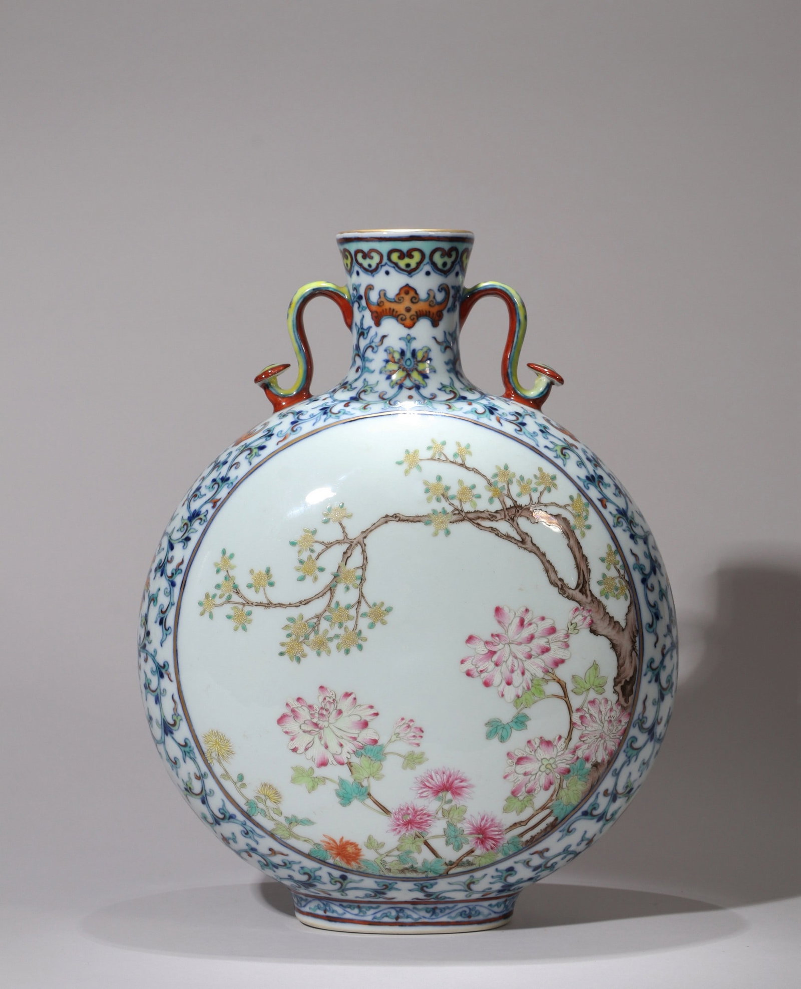 A DOUCAI FLORAL FAMILLE-ROSE FLORAL AND POEM MOONFLASK: 乾隆 斗彩缠枝花卉开光内粉彩花卉诗文如意耳扁瓶 A doucai floral