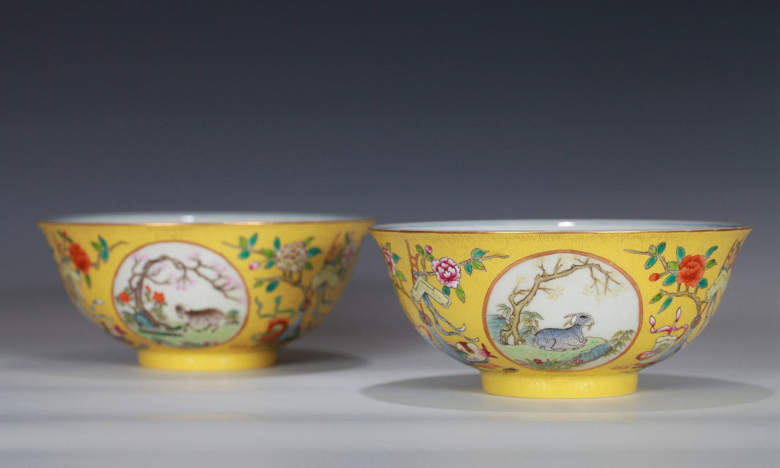 A PAIR OF YELLOW GROUND FAMILLE-ROSE SAN YANG KAI TAI BOWL: 清 黄地轧道粉彩三阳开泰碗一对 A pair of yellow ground famille-rose San Yang Kai Tai Bowl Diam.15CM Ht.7CM