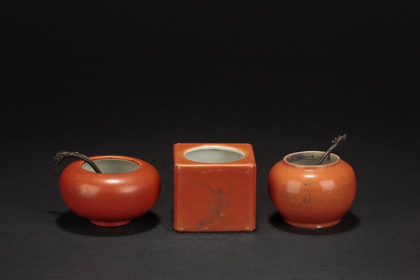 A GROUP OF THREE RED GLAZED WASHERS: The group includes three washers. One of square form, the small jar depicts orchid flowers and Chinese poems on the exterior, against orange-red glaze. The top has a circular opening, and six characte