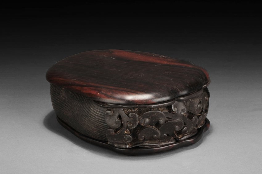 A NATURALISTCALLY CARVED STONE INKSTONE WITH COVER: The inkstone high relief carved with lingzhi on the top and sides, the reverse carved with Chinese poem and artist marks. 19th century. W: 7 1/8 in (18.1 cm) H: 2 5/8 in (6.7 cm)