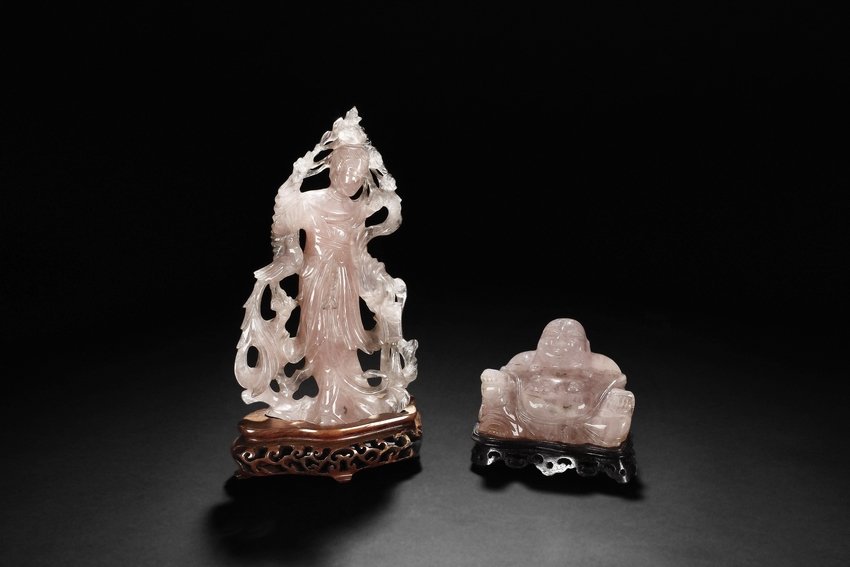 A SET OF TWO PINK CRYSTAL FIGURES: The set includes a standing figure of pink crystal carved beauty holding a lantern and twig, and a seated buddha with large belly with joyful expression. The crystal is of light pink and semi-transpar