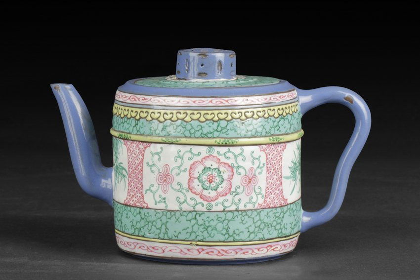 A PAINTED ZISHA STONEWARE 'FLOWERS' TEAPOT: Of cylindrical form, the body separated into four painted medallions, one side with peony flowers and vines, the other side with chrysanthemum flowers and leaves, while the medallion near handle and s