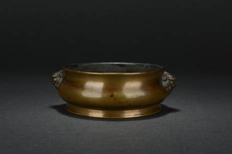 BRONZE CENSER WITH LION MASK HANDLES: Of compressed form, the censer supported by a large ring foot, the sides attached two lion mask handles, bottom bears six character XUANDE mark. Qing Dynasty period. D: 5 1/2 in (14 cm) H: 2 1/4