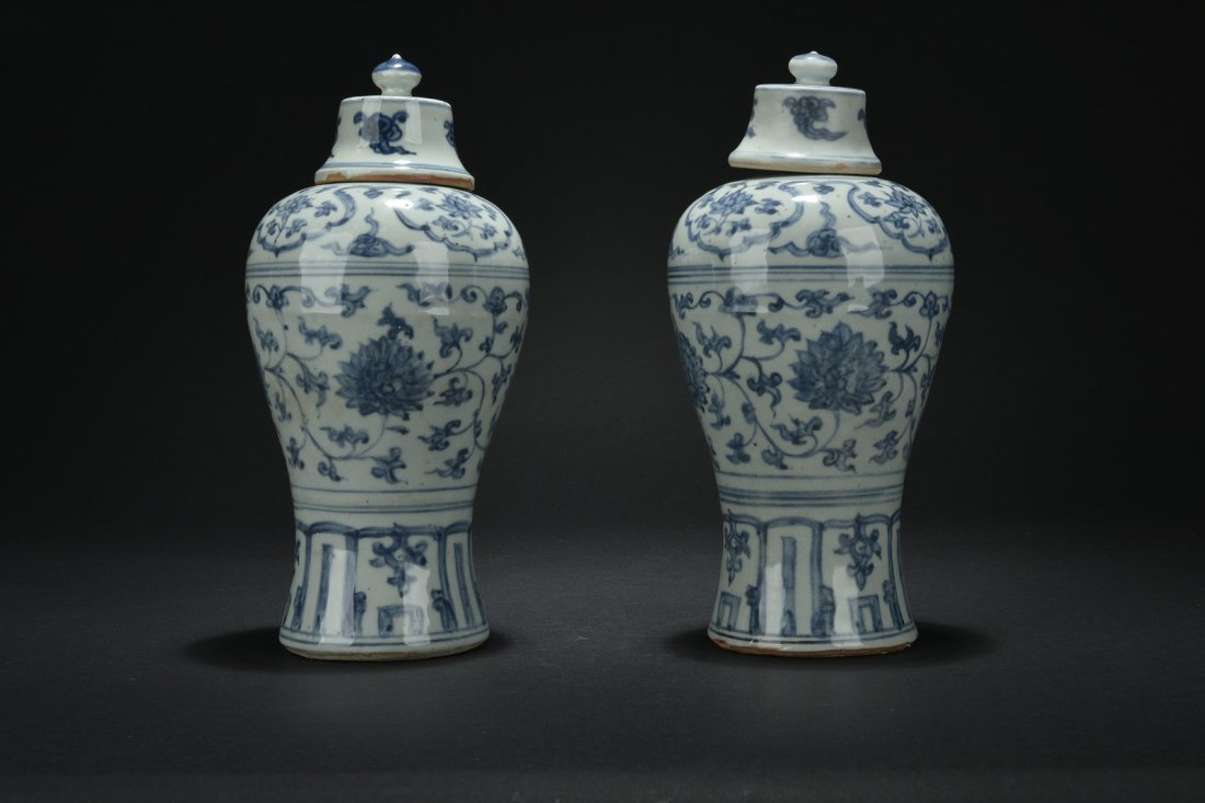 PAIR OF BLUE AND WHITE BOTTLE VASES WITH LID: Of baluster form, the blue and white vases depict floral and vine patterns, with cloud patterns on the lid, bottom remain unglazed. Ming Dynasty period. H: 12 in (30.5 cm) D: 5 1/2 in (14 cm)