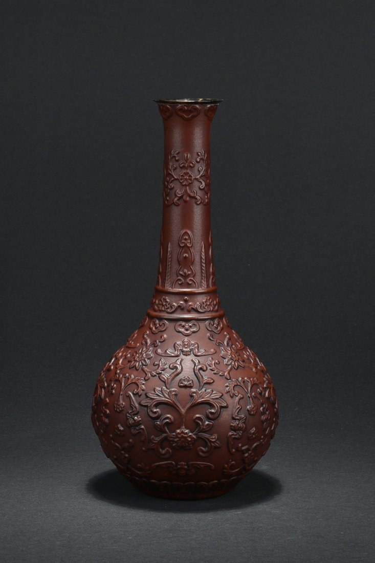 CARVED GOURD BOTTLE VASE: Of globular form, the vase carved from gourd, long neck extending to flared rim, body carved with scrolling flower patterns, bottom bears four character QIANLONG mark. H: 12 5/8 in (32.1 cm) W: 5 3/4