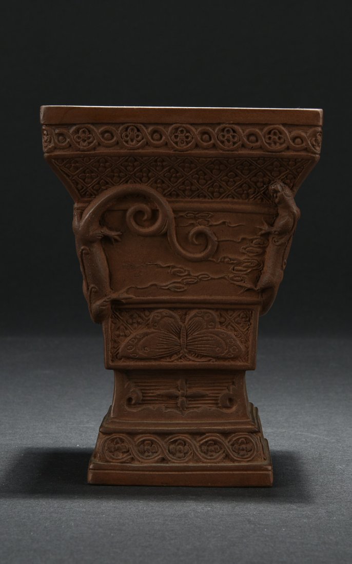YIXING ZISHA RITUAL VESSEL: Of tapering square form with defined sections, the sides decorated with butterflies, vines, and other auspicious patterns. H: 6 1/4 in (15.7 cm) W: 4 5/8 in (11.7 cm)