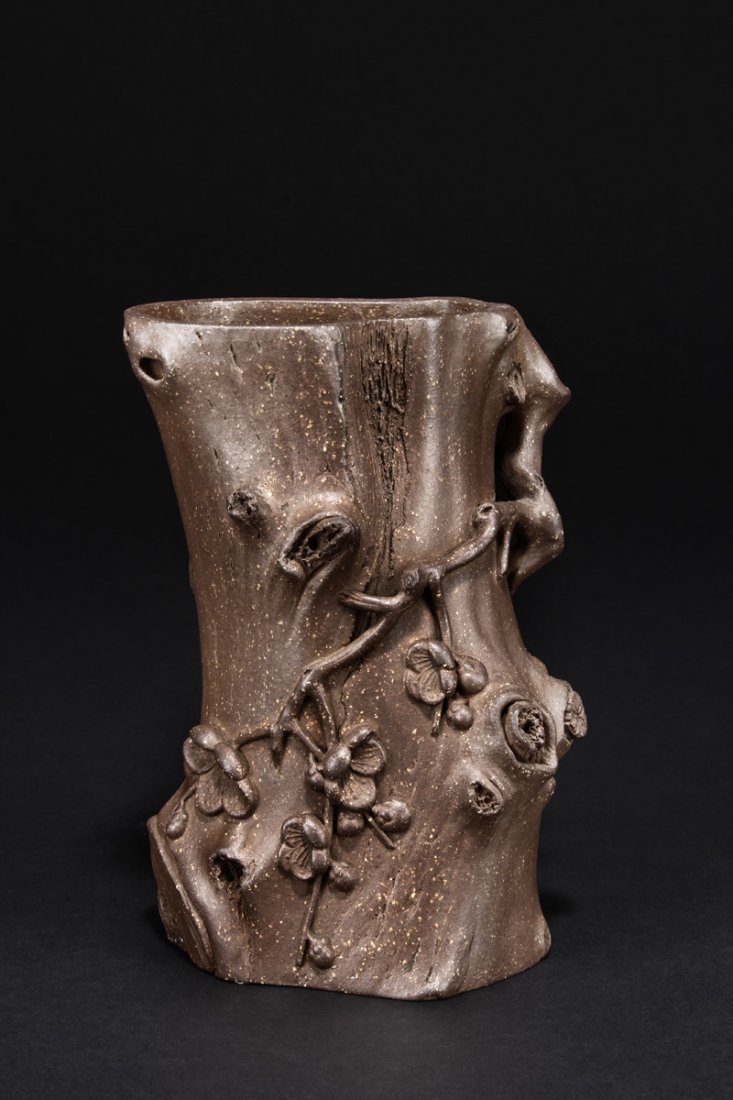 CHEN MINGYUAN: YIXING ¡°PLUM TREE TRUNK¡± BRUSH POT: The brush pot in naturalistic form, depicting a plum tree trunk, decorated with plum flowers, branches, and leaves, with fine details on the body. The clay color is of dark brown, finely grained and g