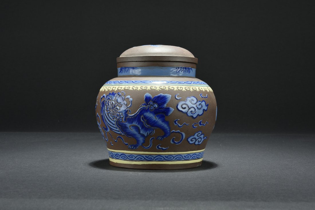 WANG NANLIN: ENAMELED YIXING ZISHA TEA JAR: The Zisha tea jar enameled on the exterior with mythical lions, clouds, flaming pearls, and auspicious patterns, artist mark Wang Nanlin. 18th century. H: 6 1/4 in (5.8 cm) D: 6 1/2 in (16.5 cm)