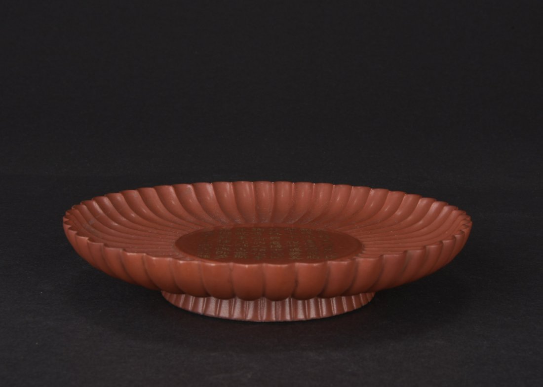 MUGHAL STYLE CINNABAR LACQUER GLAZE PORCELAIN DISH: Of chrysanthemum flower petal form in Mughal style, the dish glazed in cinnabar lacquer tone, with poetry in the center, and six character 'QIANLONG' mark on the bottom. 20th C. D: 6 3/4 in (17 cm)