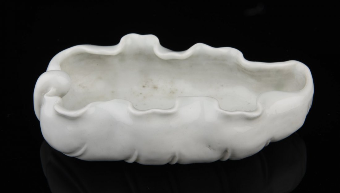 BLANC DE CHINE DEHUA WASHER: The Dehua Blanc de Chine washer is lotus leaf form, with curled edges and leafy veins, bottom bears six character 'DAOGUANG' mark. 19/20th C. L: 4 1/8 in (10.4 cm) W: 2 3/8 in (6 cm)
