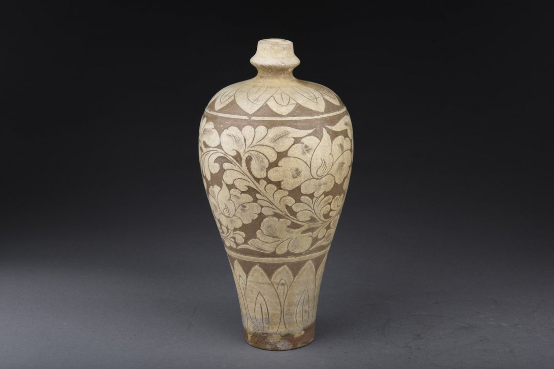 CIZHOU WARE 'FLOWERS' VASE, MEIPING: The vase' wide shoulder elegantly tapers downwards to small rounded bottom, the bottom painted with flowers between scrolling leaves band, bottom unglazed. H: 10 1/2 in (26.7 cm) D: 5 in (12.7 cm)