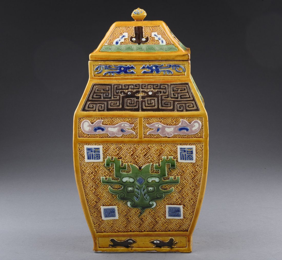 CARVED SANCAI JAR WITH COVER, ZUN: The Sancai jar depicts dragons, mythical animals, Fu character, and key-fret patterns on the body, all against yellow ground, bottom unglazed, includes rectangular cover in same motif. 19th C. H: 14 1