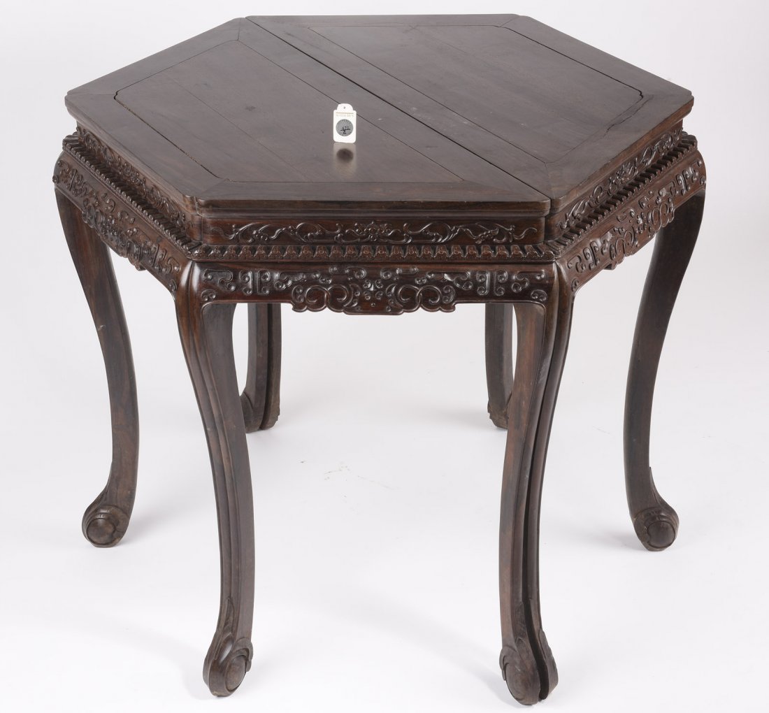 PAIR OF ZITAN CONSOLE TABLES: The pair of console tables made from Zitna, when combined they form a perfect hexagonal form, with scrolling apron well-carved with flowering vines which continue around the back, resting on four slig