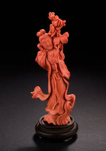 RED CORAL CARVED 'LADY' FIGURE: The well-carved figure depicts a standing lady dressed in flowing robe, left hand holding a large brooch of flowers branch, and right hand next to her head, the color of orange-red, complete with wood