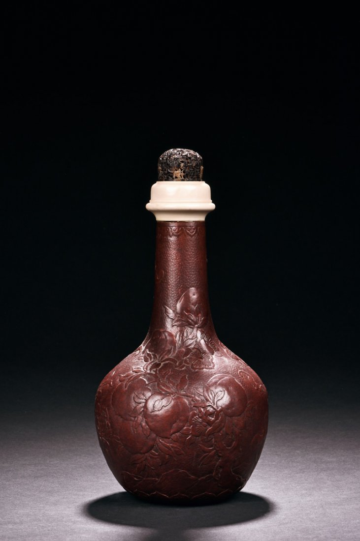 CARVED GOURD BOTTLE VASE: Of globular form with long and thin neck, the bottle vase made from gourd, the surface carved with peaches, flowers, and vines, all above lappet patterns, the lid made from a combination of bone and t
