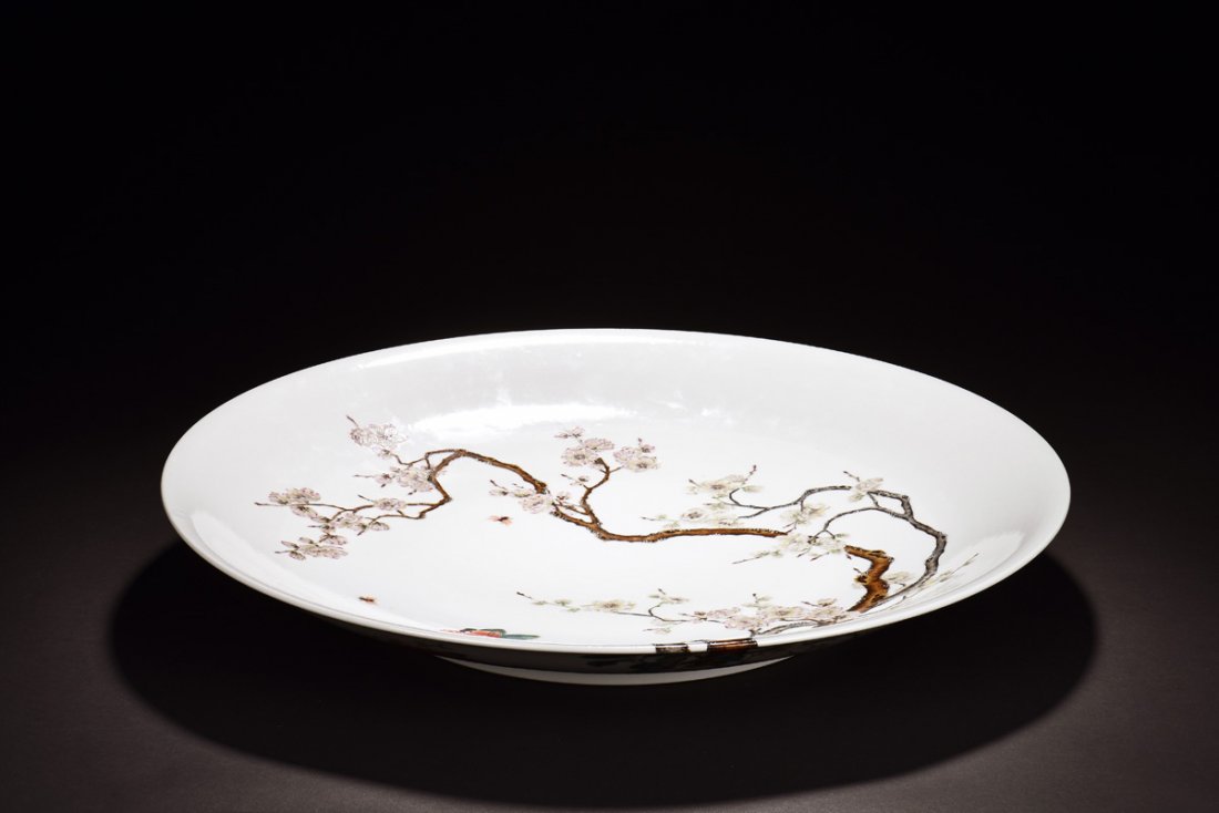 FAMILLE ROSE 'CAMELLIA' FLOWERS DISH: Painted in famille rose, the dish depicts blossoming Camellia flowers with bees buzzing about, against white glaze, bottom bears six character YONGZHENG mark. Height: 2 1/4 in (5.7 cm) Diameter: 20 1/