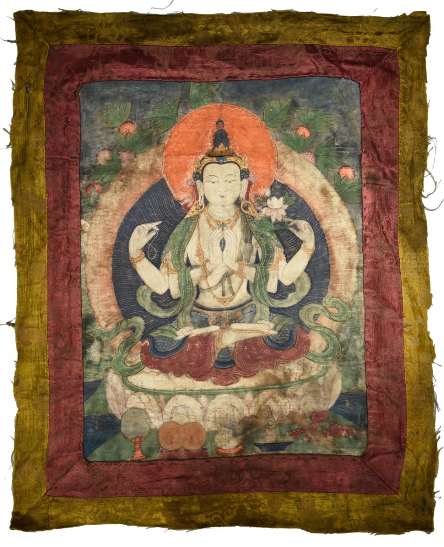 SILK FOUR-ARM AVALOKITESVARA THANGKA: The silk Thangka depicts Four-Arm Avalokitesvara seated on lotus throne pad in dhyanasana, two arms clasped praying, one arm holding a lotus flower, the other holding praying beads, eyes open in seren